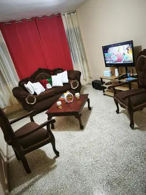 a living room with a couch and chairs and a tv at Espacio acogedor y funcional in SJM
