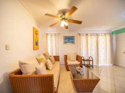 a living room with a couch and a ceiling fan at Charming 1BR Apt with Pool Walk to Sosua Beach in Sosúa