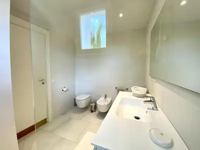 a bathroom with a sink and a toilet and a mirror at Luxury Penthouse with roof top & infinitive pool ocean view in Tracadero Beach Club in Bayahibe