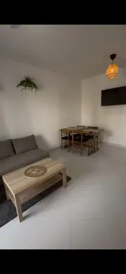 a living room with a couch and a table at Maravilla Bayahibe , Stylish Apartment, Pool a Wifi in Bayahibe
