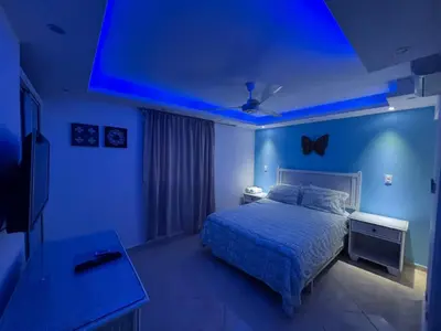 a blue room with a bed and a blue ceiling at Garden Condos 43 Modern Condo in Sosua center in Sosúa