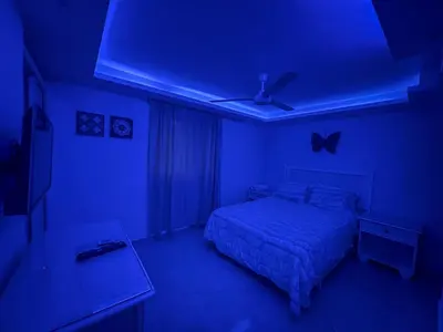 a blue room with a bed and a blue ceiling at Garden Condos 43 Modern Condo in Sosua center in Sosúa