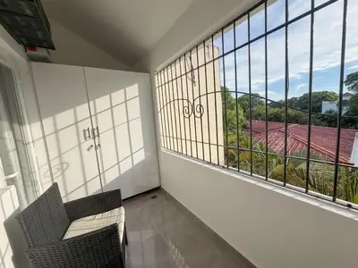 a room with two chairs and a large window at Stylish Sosua 2 BR apartment near everything in Sosúa