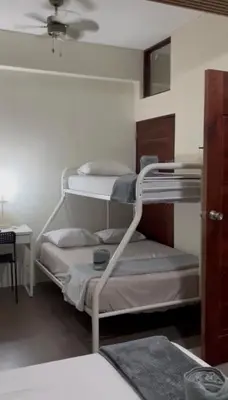 a bedroom with two bunk beds with a ceiling at Yuloren Hostal 1 min del monumento & 5 de Agora Mall in Santiago de los Caballeros