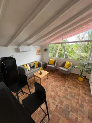 a living room with a couch and a table at Bright studio in the heart of Las Galeras in Las Galeras