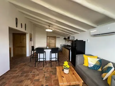 a living room with a couch and a table at Bright studio in the heart of Las Galeras in Las Galeras