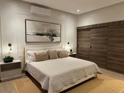 a bedroom with a bed and a painting on the wall at Luxury Villa in Punta Cana in Punta Cana