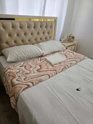 a bed with a headboard and pillows on it at Presmita rose 24 in Punta Cana