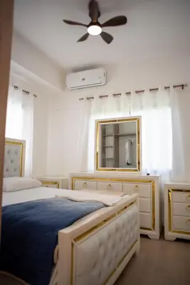 a bedroom with two beds and a ceiling fan at Presmita rose 24 in Punta Cana