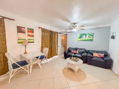 a living room with a couch and a table at Garden Condos APT 44 - Comfy 1BR APT in Sosua in Sosúa