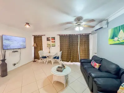 a living room with a couch and a table at Garden Condos APT 44 - Comfy 1BR APT in Sosua in Sosúa