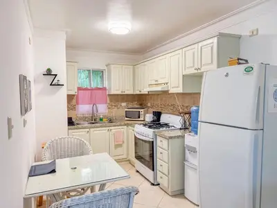 a kitchen with white appliances and a white refrigerator at Garden Condos APT 44 - Comfy 1BR APT in Sosua in Sosúa
