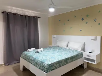 a bedroom with a bed with blue stars on the wall at Garden Condos 48 - Friendly 1BR APT Sosua Center in Sosúa