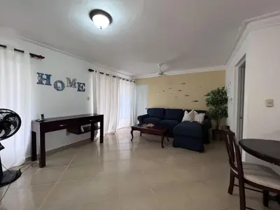 a living room with a blue couch and a piano at Garden Condos 48 - Friendly 1BR APT Sosua Center in Sosúa
