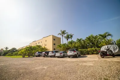 a row of cars parked in a parking lot at Garden Condos 7 - Central Apartment in Strip in Sosúa