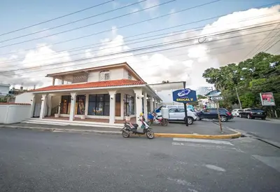 a motorcycle parked in front of a store on a street at Central 1BR APT - 1 minute Walking from Rumba in Sosúa