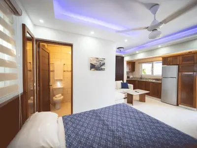 a bedroom with a bed and a bathroom at Casa de Compai Studio 1 AC WiFi Prime Location in Sosúa