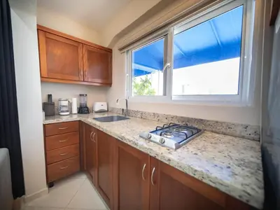 a kitchen with a sink and a window at Casa de Compai Studio 1 AC WiFi Prime Location in Sosúa