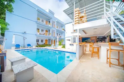 a swimming pool in the middle of a house at CC 3 Casa de Compai Unit 3 Steps to Everything in Sosúa