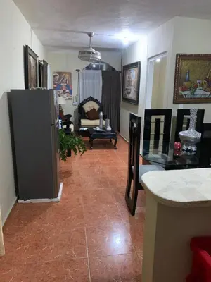 a living room with a refrigerator and a couch at gina apartamento in Monte Llano