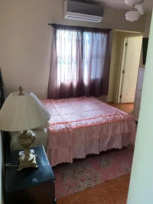 a bedroom with a bed and a lamp on a table at gina apartamento in Monte Llano