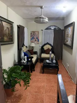 a living room with a couch and two tables at gina apartamento in Monte Llano