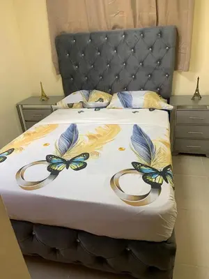 a bed with a black headboard and gold rings on it at Comfortable Apartament 20 Minutes from the airport in San Isidro