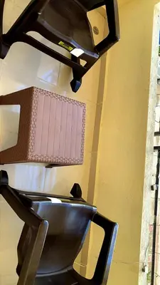 a black chair sitting next to a wall at Comfortable Apartament 20 Minutes from the airport in San Isidro