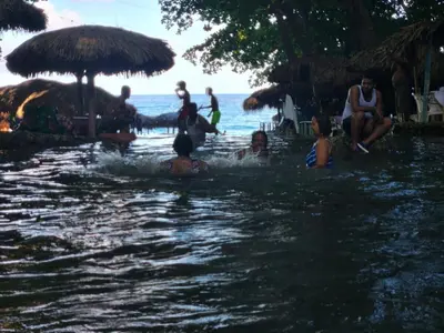 a group of people in the water at a beach at 2 Bdrm, 1 Bath, Wifi, Near River and Beach,4L in Paraíso