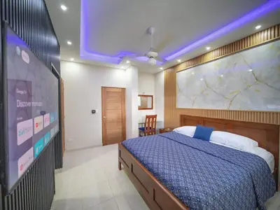 a bedroom with a bed and a large screen at Casa de Compai Unit 4 Comfort in Central Sosua in Sosúa