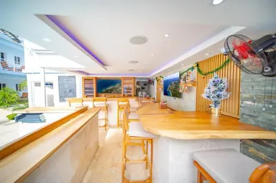 a bar in a restaurant with wooden counter tops at Casa de Compai Unit 4 Comfort in Central Sosua in Sosúa