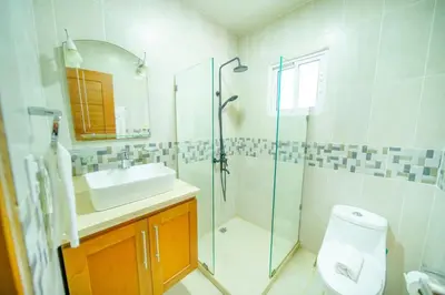 a bathroom with a shower sink and a toilet at Stylish 1BR in Sosua Walkable & Pool Fast WIFi in Sosúa
