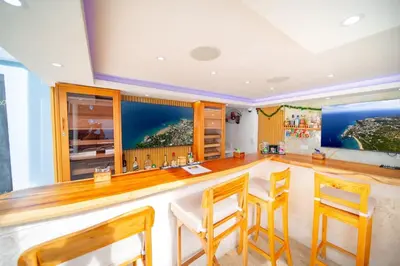 a bar in a room with chairs and tables at 1BR Apt with Pool & Cigar Bar Lounge Casa de Compai in Sosúa