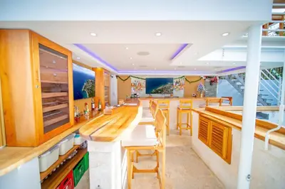 a kitchen with a bar with wooden tables and chairs at CC 7 Casa de Compai Unit 7 AC WiFi Prime Location in Sosúa