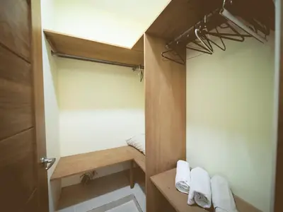a small bathroom with a closet with white towels at CC 7 Casa de Compai Unit 7 AC WiFi Prime Location in Sosúa
