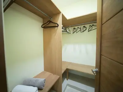 a bathroom with a door and a towel on a bench at Casa de Compai Unit 9 AC WiFi Prime Location in Sosúa