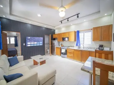 a living room with a couch and a kitchen at Casa de Compai Unit 9 AC WiFi Prime Location in Sosúa