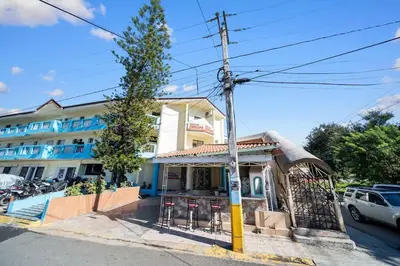 a building with a bar with stools in front of it at Centric Studio in Sosua Center Pool & Workspace in Sosúa