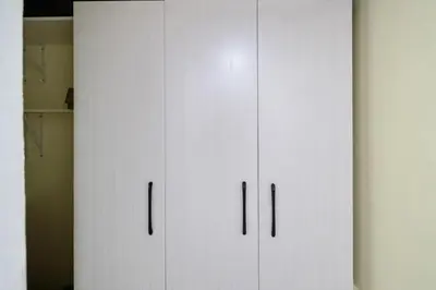 a white cabinet with black handles in a room at Centric Studio in Sosua Center Pool & Workspace in Sosúa