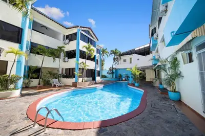 a swimming pool in front of a building at Centric Studio in Sosua Center Pool & Workspace in Sosúa
