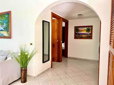 a hallway with a room with a bed and a mirror at 2 Bedroom Villa with private Pool in Sosua in Sosúa