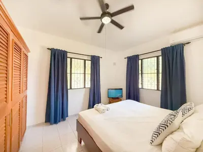 a bedroom with a bed and a ceiling fan at 2 Bedroom Villa with private Pool in Sosua in Sosúa