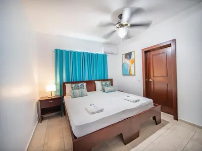 a bedroom with a bed and a ceiling fan at 14 Bedroom Villa 2 mins from Sosua in Sosúa