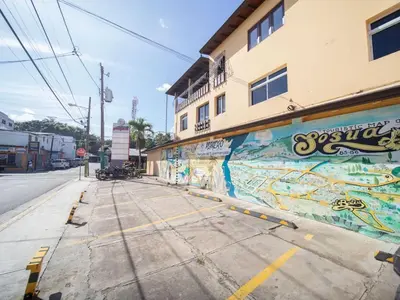 an empty street with graffiti on the side of a building at Colonial 2BR Apartment 2 mins walk to beach in Sosúa