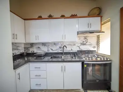 a kitchen with white cabinets and a sink at Colonial 2BR Apartment 2 mins walk to beach in Sosúa