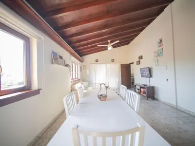 a dining room with a white table and white chairs at HUGE Balcony APT next to HARD ROCK CAFE and Beach in Sosúa
