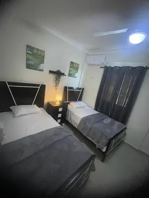 a room with two beds and a lamp at 2 Bdrm 1 Bath Near River and Beach, 3L, Paraíso, Barahona in Paraíso