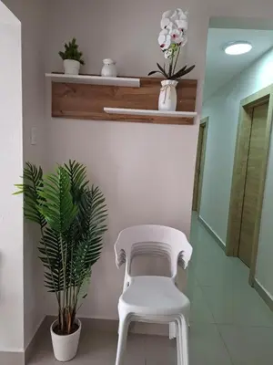 a white chair in a hallway with a plant at Apartment in Santo Domingo in El Caliche