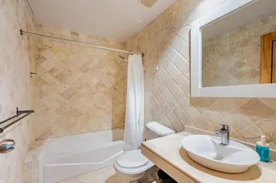 a bathroom with a sink and a toilet and a tub at Large apartment at the foot of the beach in Punta Cana