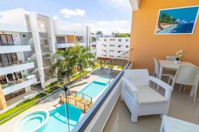an apartment with a balcony with a swimming pool at Stylish 2BR Apartment in the Heart of Bayahibe in San Rafael del Yuma